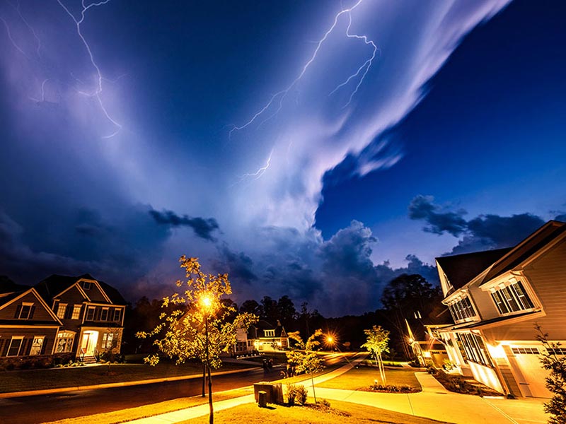 Residential neighborhood under a very stormy sky with dark clouds and thunder